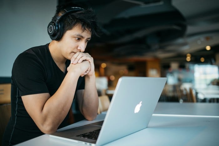 Young man studying on Macbook